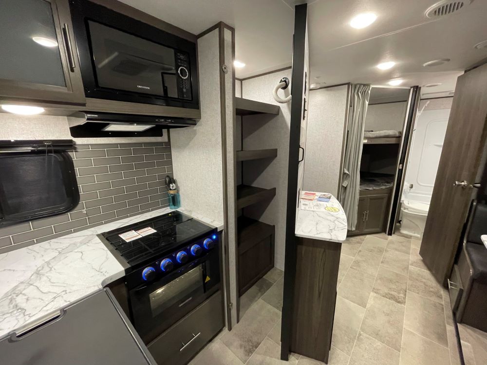 Photo of a hidden pantry in an RV. 
Camper Design Trends in 2021