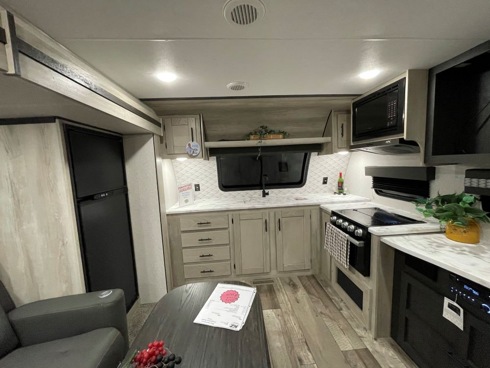 Photo of tile backsplash and solid surface counter tops in an RV. Camper Design Trends in 2021