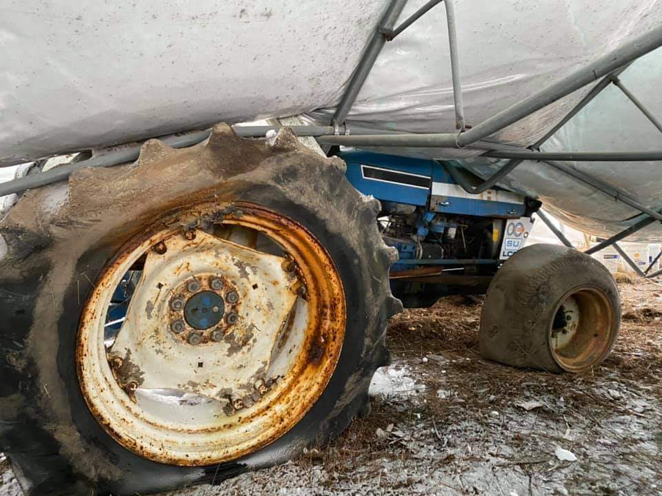 collapsed greenhouse on tractor