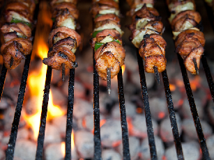 Image of food on grill with flames