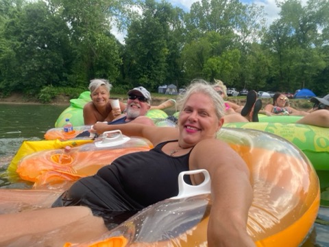 people floating on the river in tubes