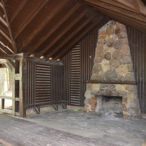 A large stone fireplace built by the CCC in 1937 and the surrounding covered picnic pavilion