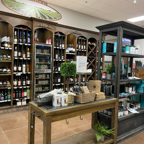 A display case shows bottles of wine and gift items at Prasek's.