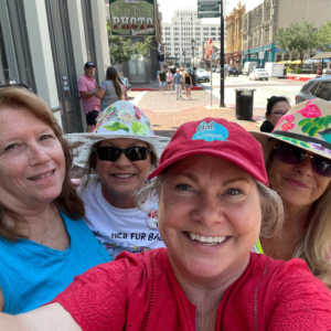 Lisa Dempsey and three women in colorful hats are learing how to start camping like a girl on Galveston Island.