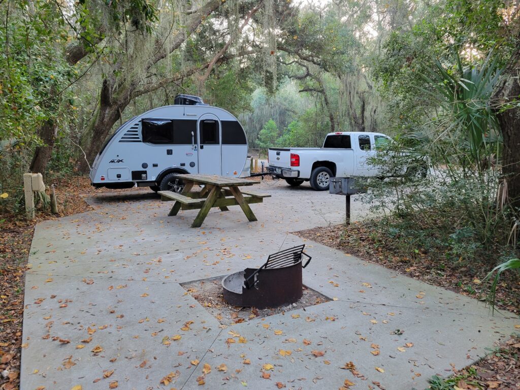 A campsite at Fort Clinch with a camper and truck.