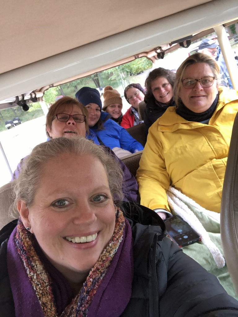 Seven women bundled up for a cold Jeep Safari Tour at Custer State Park