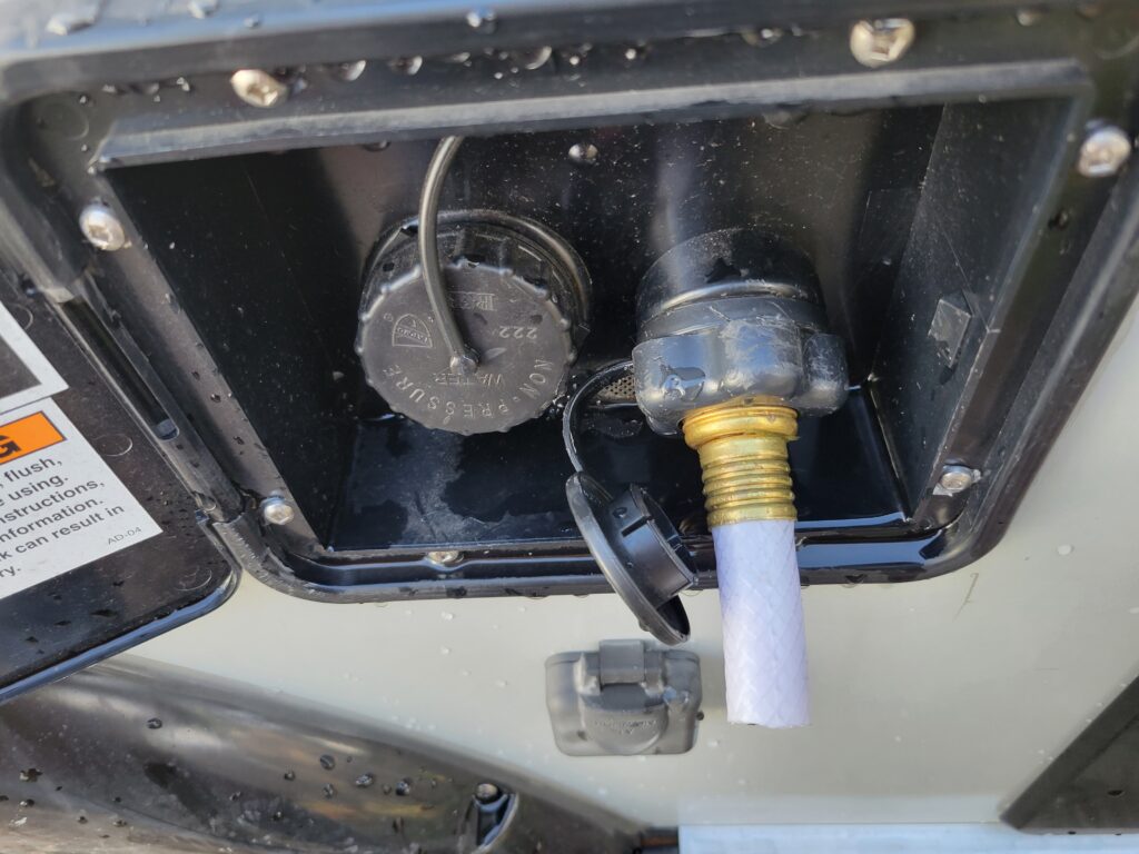 An image of a cut hose connected to the water line in a camper.