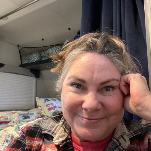 Lisa Dempsey sitting inside her trailer keeping warm during a hard freeze in Texas