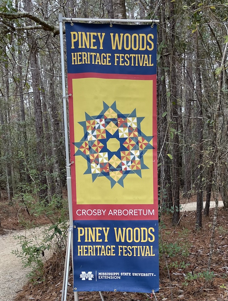 Piney Woods Heritage Festival sign at the entrance to Crosby Arboretum