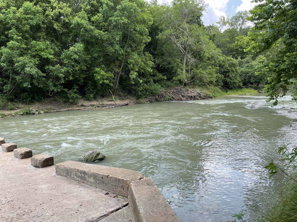 A Cement walkable bridge crosses the San Marcos River in the Palmetto State Park.